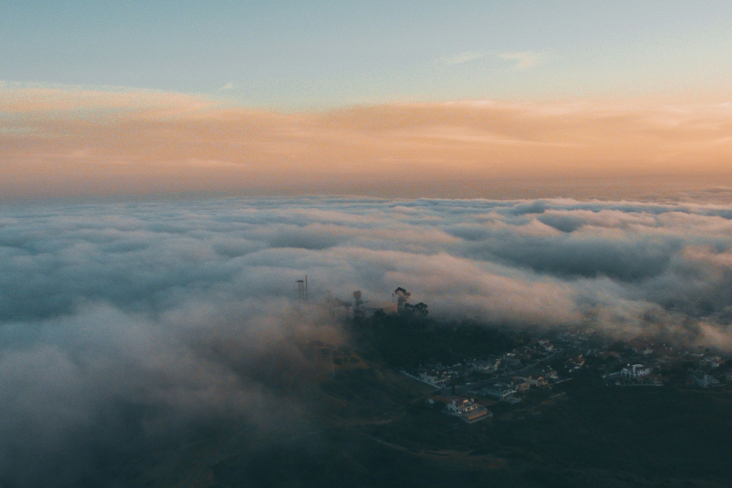 Marine fog rolling over the hills of North County San Diego at sunset